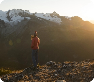 Hiker on mountain at sunset